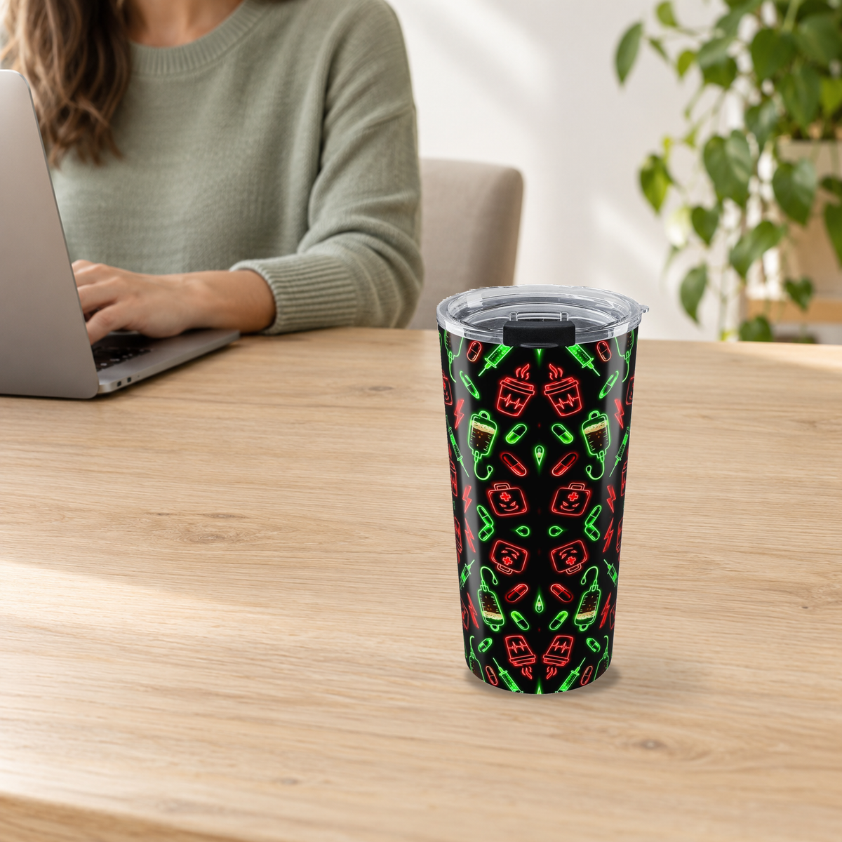 Neon Espresso Pattern Tumbler in the 20oz size on a wooden desk beside an adult using a laptop