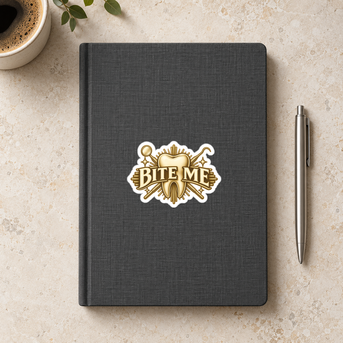 Bite Me Crest Sticker in the 3 × 3 inch size shown on a charcoal notebook in an illustrative lifestyle mockup