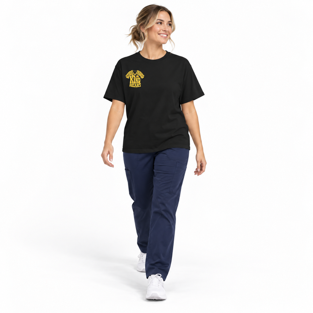 Healthcare professional walking in Black Steady Hands Kind Heart Comfort Colors 1717 tee, white background