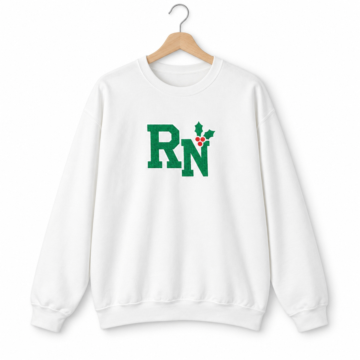 White RN holly center embroidered Gildan 18000 sweatshirt on a hanger
