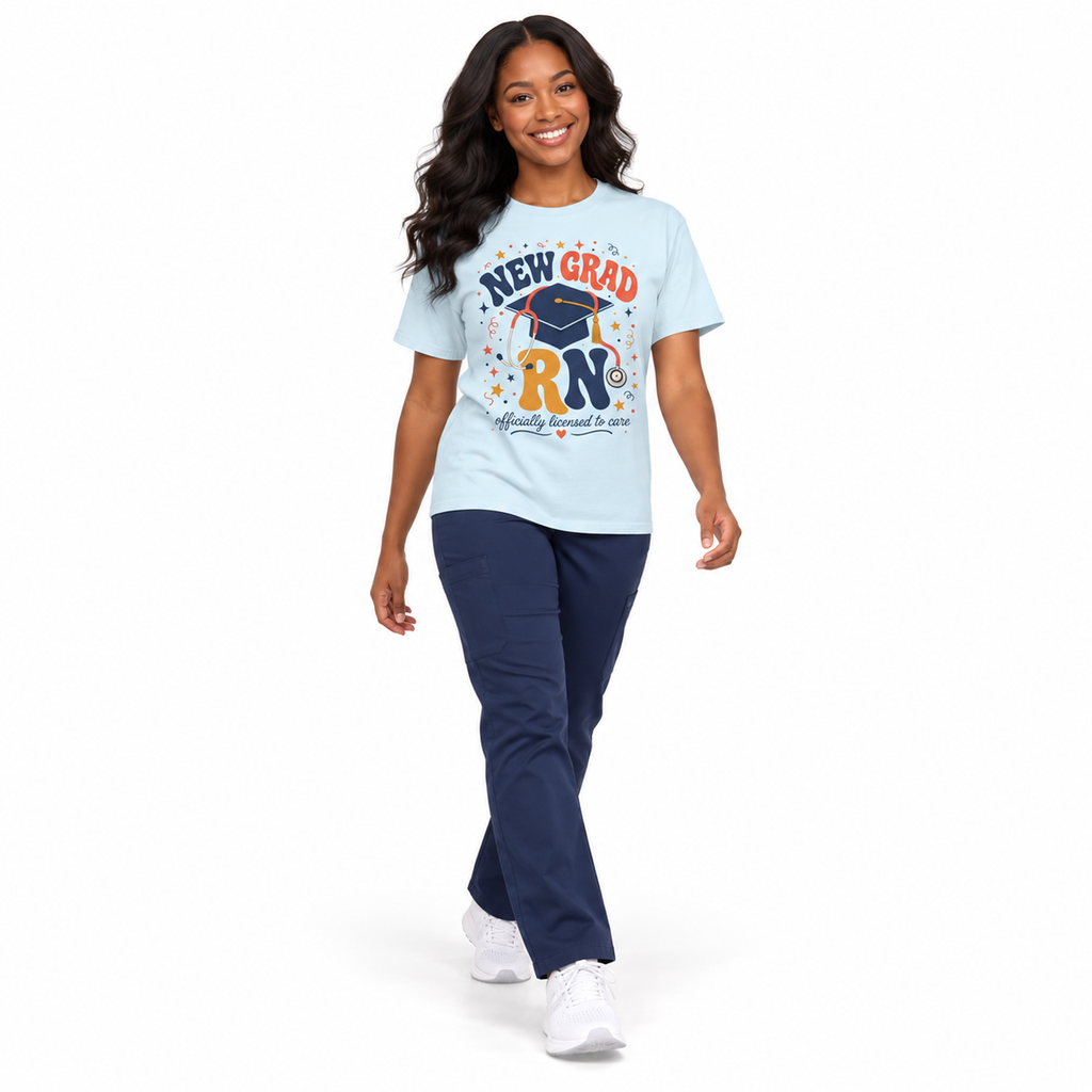 Healthcare professional walking in a Chambray New Grad RN Comfort Colors tee with navy scrub pants on white