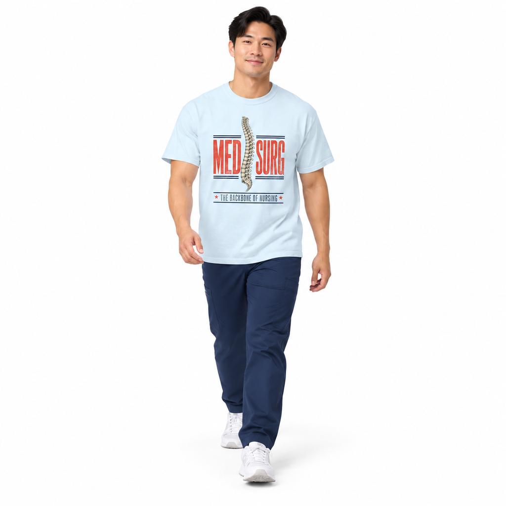 Nurse walking in a Chambray Med Surg Comfort Colors tee with navy scrub pants on white