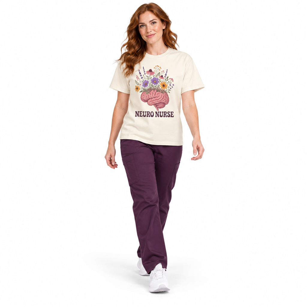 Nurse walking in an Ivory Neuro Nurse Comfort Colors tee with dark plum scrub pants on white