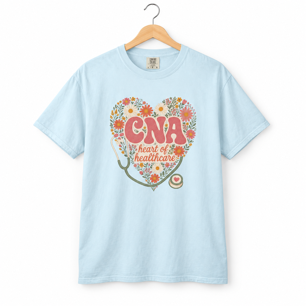 Chambray CNA Heart of Healthcare floral tee on a hanger against white