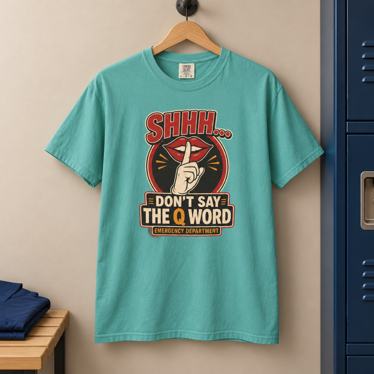 Seafoam Don’t Say the Q Word shirt on a hanger in a tidy medical staff locker area
