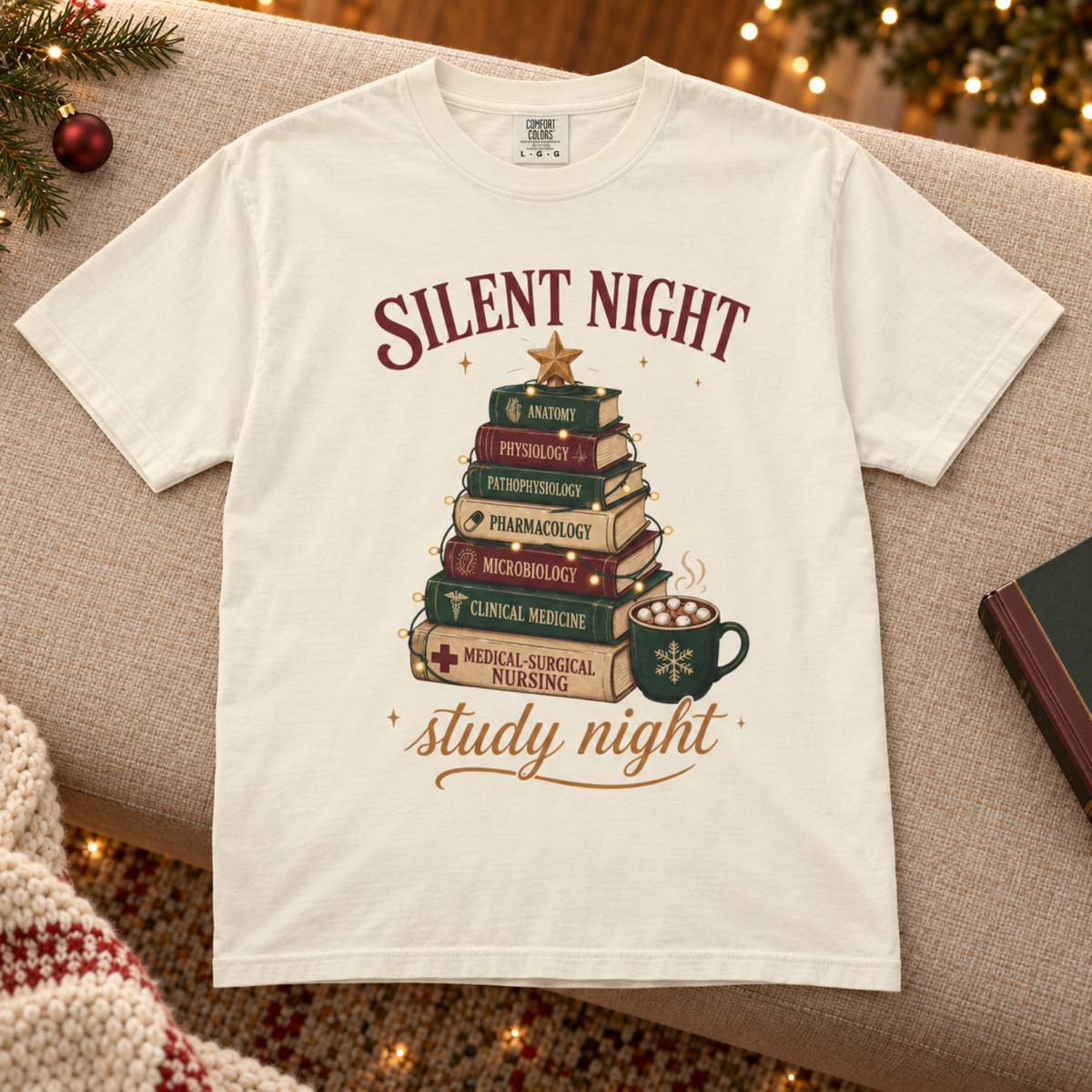 Ivory Silent Night Study Night medical student Christmas tee flat lay on a cozy lounge bench with restrained holiday styling