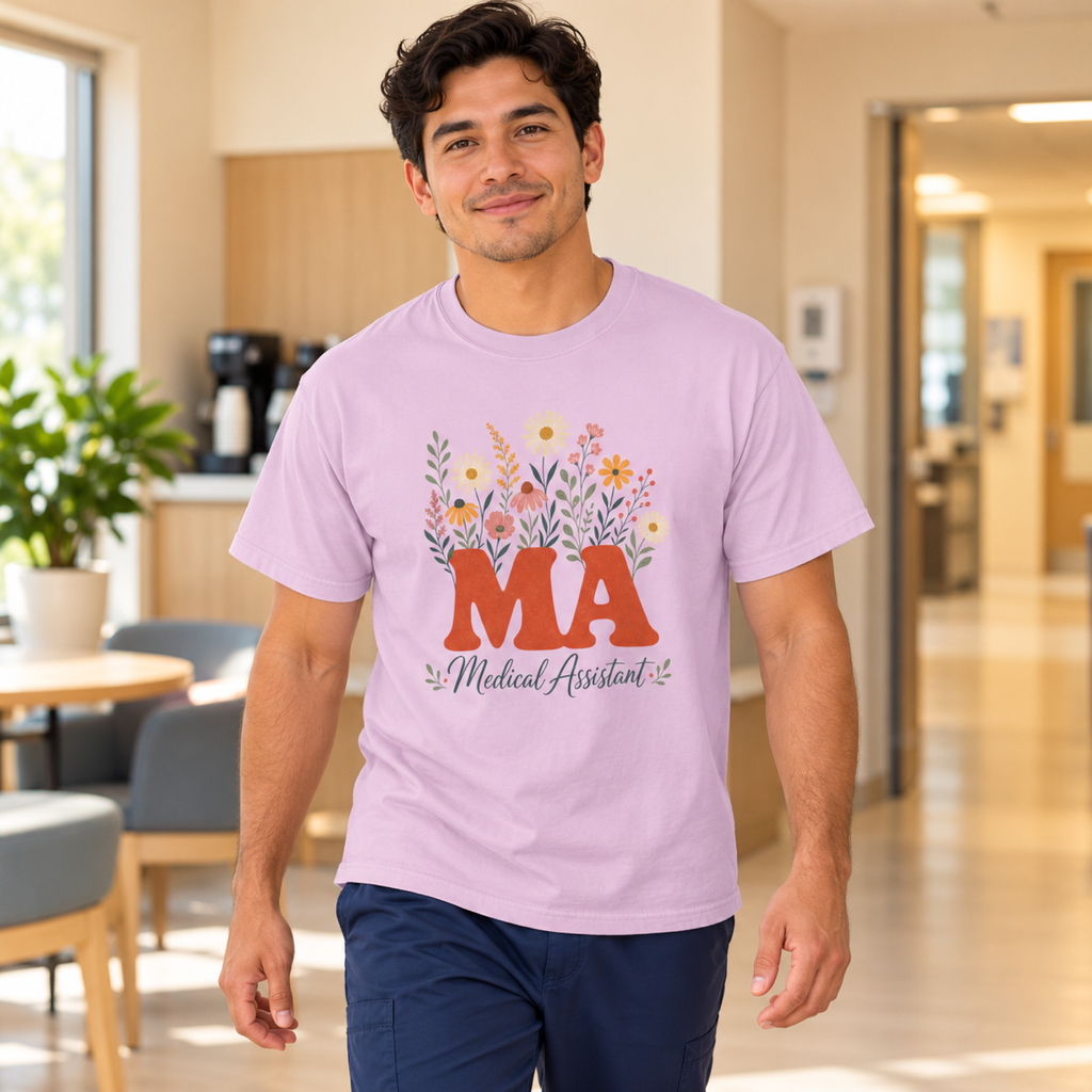 Medical assistant wearing an Orchid purple floral MA tee with navy scrub trousers in a warm clinic staff lounge