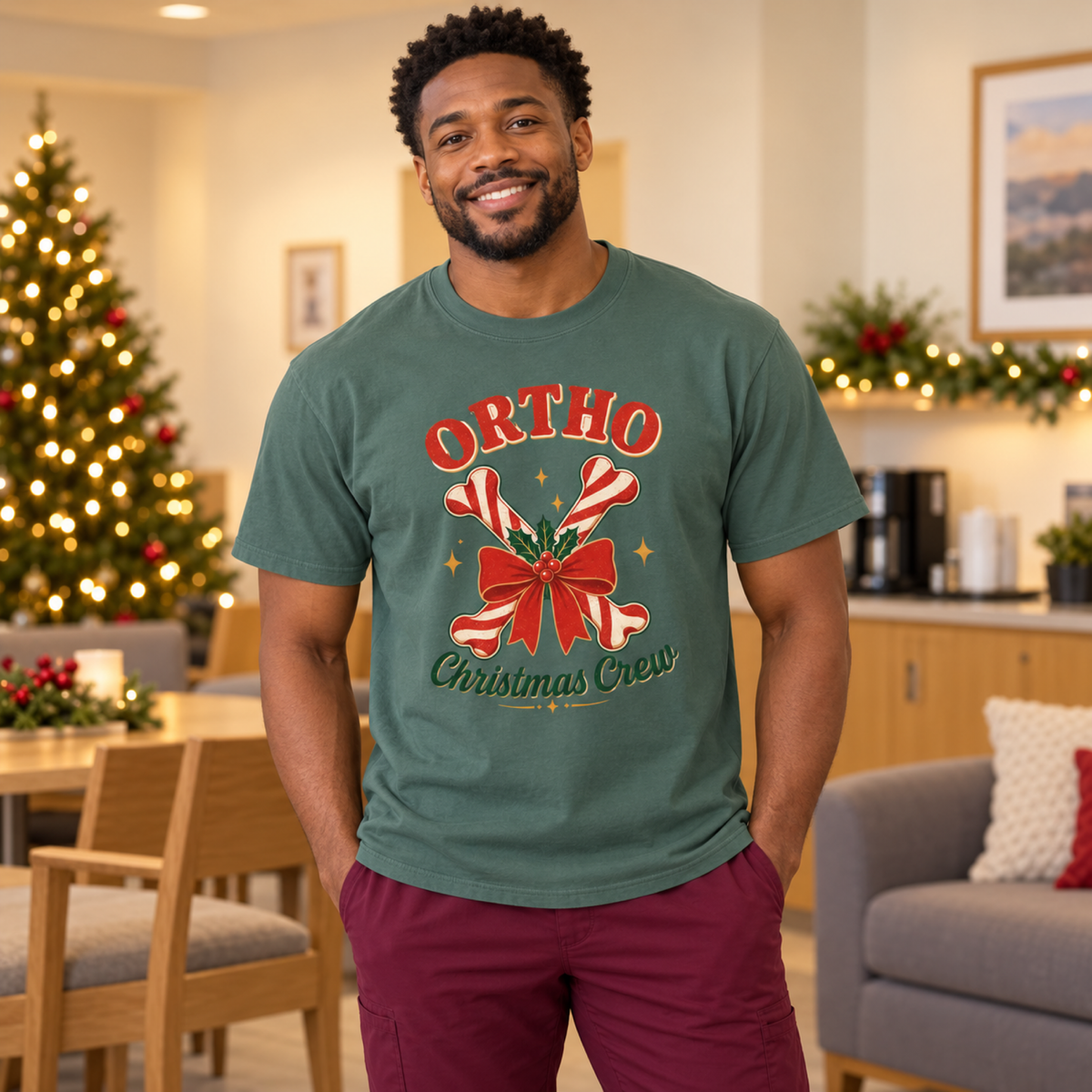 Orthopedic healthcare professional wearing a Blue Spruce Ortho Christmas Crew tee and burgundy scrub trousers in a festive staff lounge