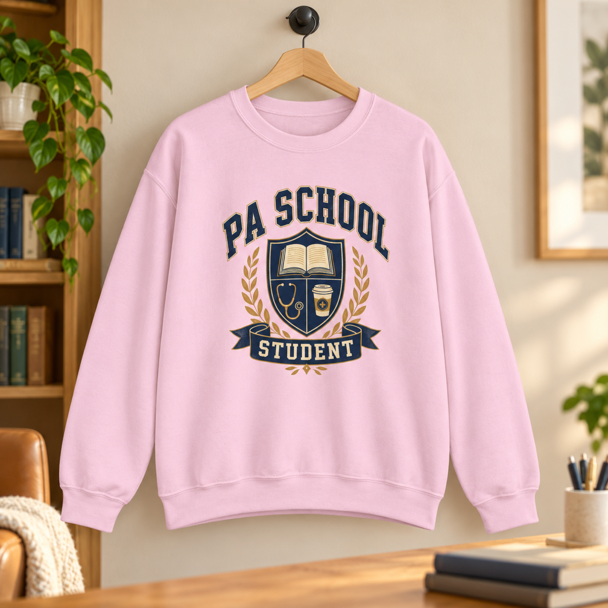 Light Pink PA School Student sweatshirt hanging in a warm study space