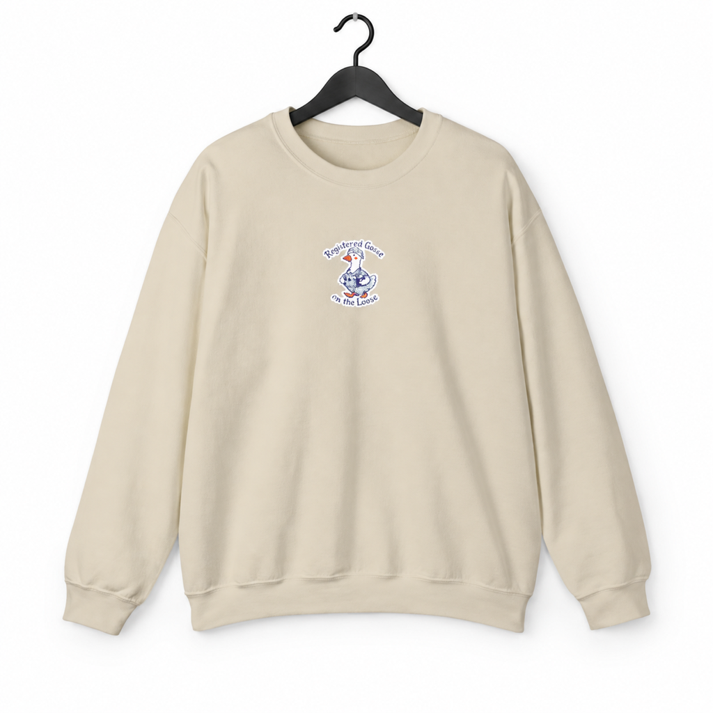 Sand embroidered goose sweatshirt on hanger against white