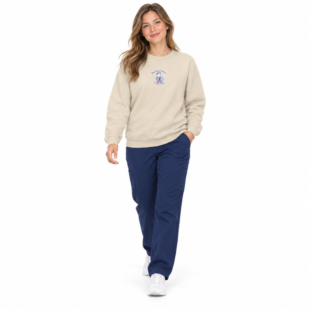 Sand embroidered goose sweatshirt worn by clinician in navy scrubs on white