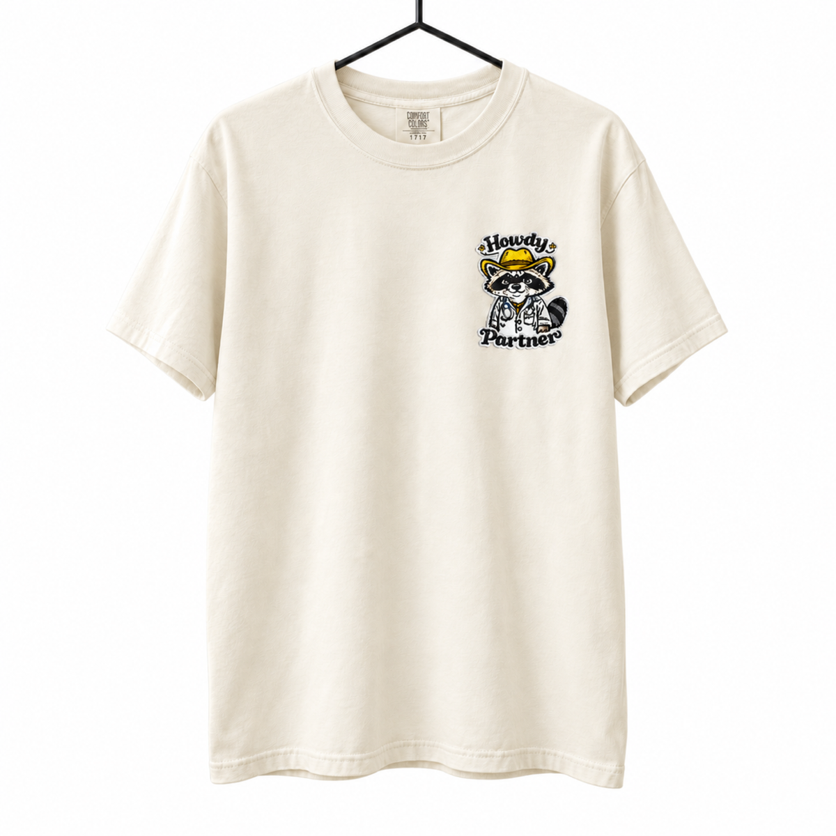 Howdy Partner Raccoon Doctor Embroidered Shirt on a hanger against a pure white background