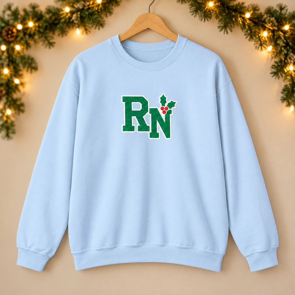 RN Holly Center Embroidered Sweatshirt, Christmas Nurse Gildan Crewneck in Light Blue — product in warm setting