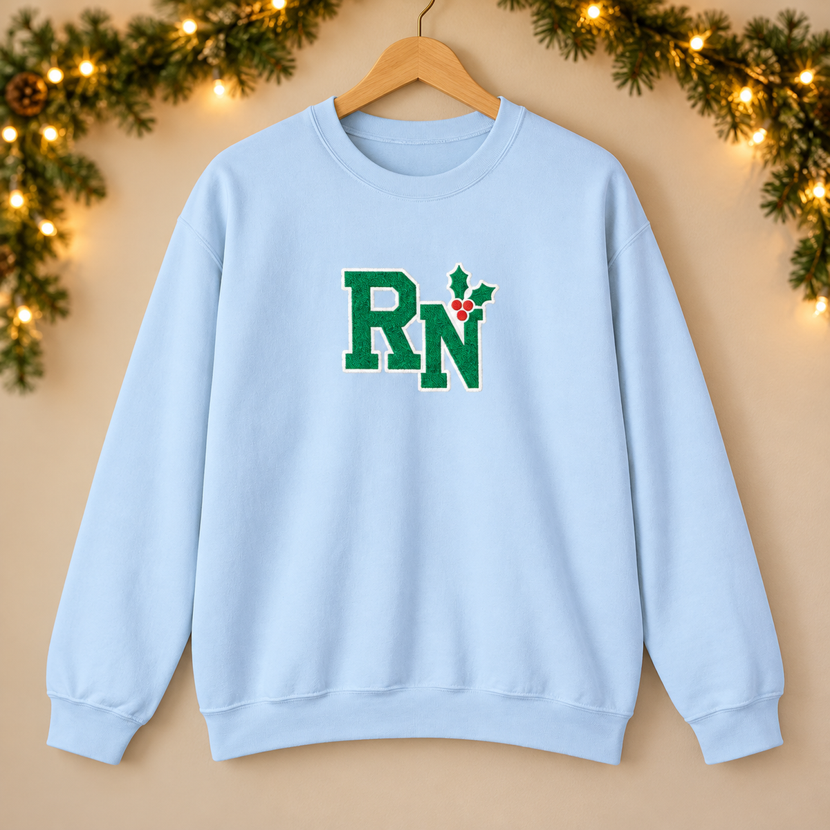 RN Holly Center Embroidered Sweatshirt, Christmas Nurse Gildan Crewneck in Light Blue — product in warm setting
