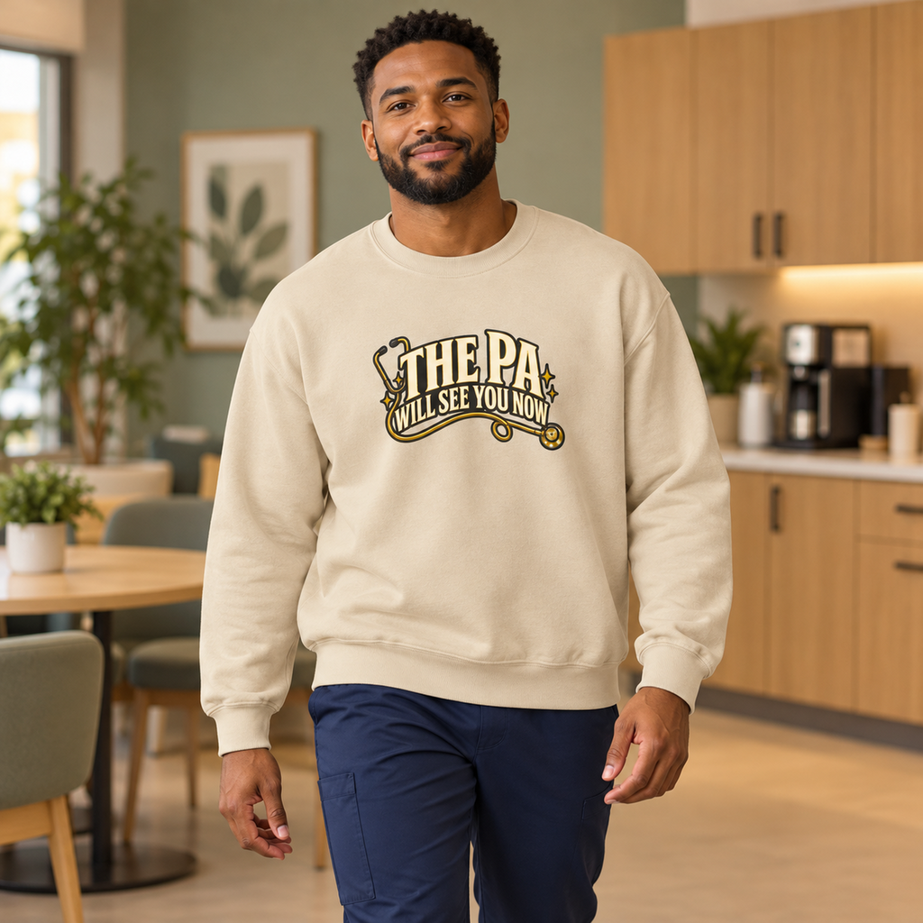 The PA Will See You Now Sweatshirt in Sand — model in warm medical setting