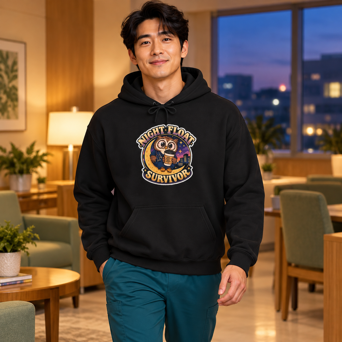 Night Float Survivor Hoodie in Black — model in warm medical setting