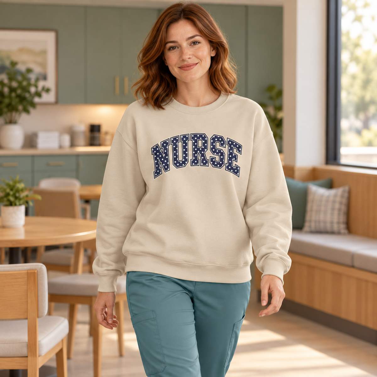 Nurse Polka Dot Varsity Sweatshirt in Sand — model in warm medical setting
