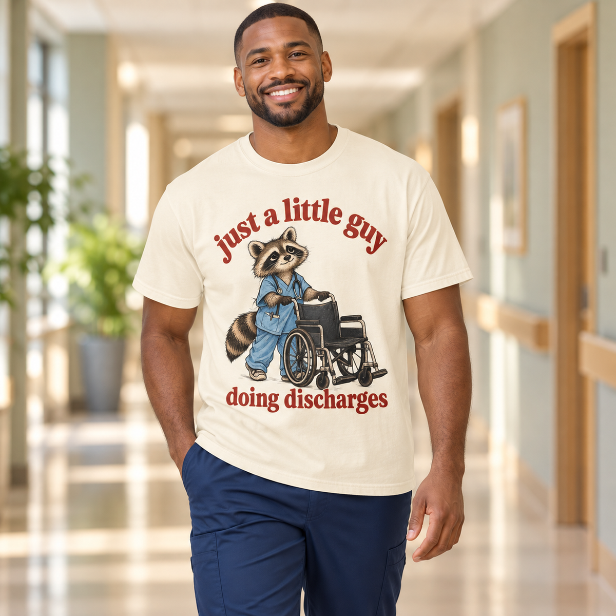 Just a Little Guy Doing Discharges Shirt in Ivory — model in warm medical setting